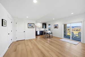 Office featuring light wood-type flooring, recessed lighting, and a mountain view