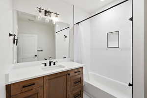 Full bath featuring vanity and shower / bath combo with shower curtain