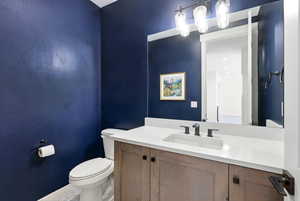 Bathroom featuring vanity and toilet
