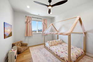 Bedroom featuring ceiling fan, wood finished floors, a mountain view, and recessed lighting
