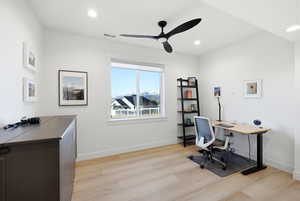 Home office featuring light wood-style flooring, ceiling fan, and recessed lighting
