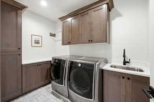 Laundry room with cabinet space and washer and clothes dryer