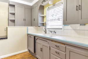 Kitchen featuring tile countertops and open shelves.Colors may be updated in person.