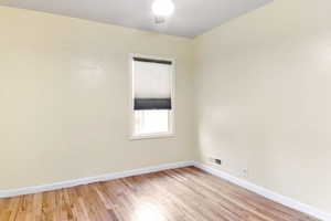 Second bedroom with wood flooring