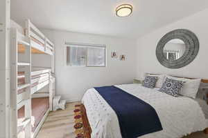 Bedroom with light wood-style flooring and baseboards