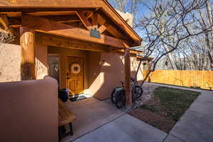 Doorway to property featuring stucco siding
