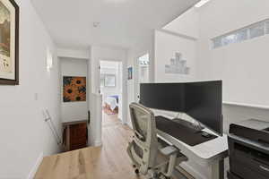 Office area featuring light wood finished floors and baseboards