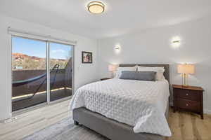 Bedroom featuring access to outside and light wood-style flooring