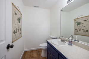 Bathroom with vanity and dark tile patterned floors