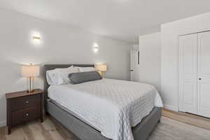 Bedroom featuring light wood-style flooring and a closet
