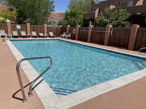 Community pool with a patio