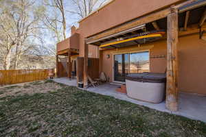 Rear view of house featuring stucco siding and a patio