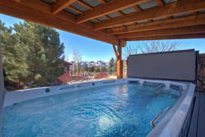 View of pool featuring a mountain view and a hot tub