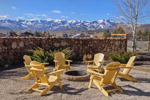View of patio featuring an outdoor fire pit and a mountain view