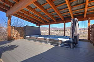 Wooden terrace featuring a mountain view
