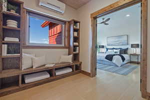 Living area featuring light wood-type flooring, ceiling fan, and wood ceiling