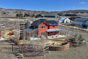 Rear view of property with solar panels, a fire pit, a mountain view, and a patio