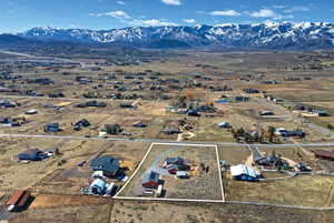 View of property location with property boundaries highlighted, mountains, and nearby suburban area