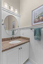 Bathroom with vanity and wainscoting