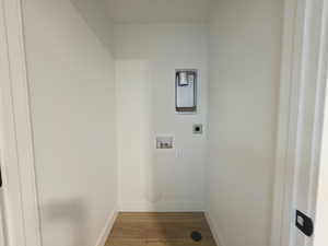 Laundry room featuring washer hookup, light wood-type flooring, and electric dryer hookup