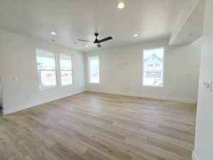 Unfurnished room with a textured ceiling, light wood-style flooring, recessed lighting, and a ceiling fan