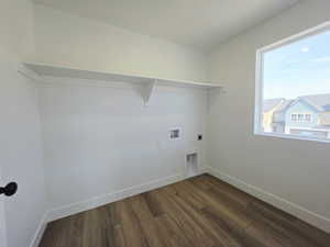 Laundry area featuring dark wood finished floors, hookup for an electric dryer, and washer hookup