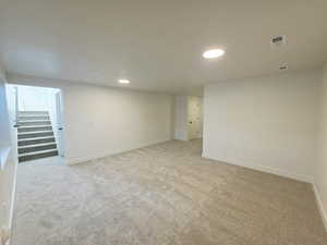 Spare room with light carpet and recessed lighting