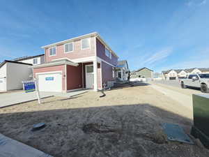 View of front facade with a residential view, an attached garage, and concrete driveway