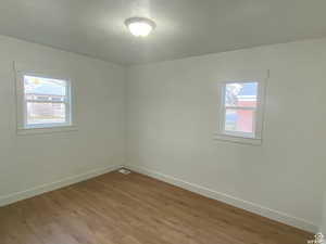 Unfurnished room with wood finished floors and a textured ceiling