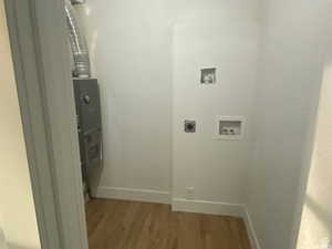 Laundry room with washer hookup, wood finished floors, and electric dryer hookup