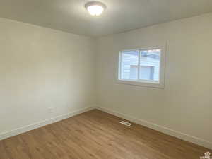 Unfurnished room featuring light wood-style flooring and baseboards