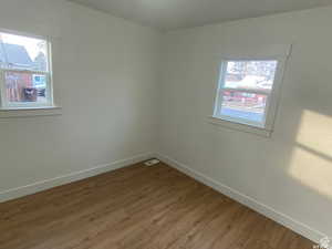 Spare room featuring wood finished floors and baseboards