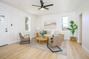 Living room featuring light wood finished floors and ceiling fan