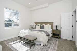 Carpeted bedroom with recessed lighting and baseboards