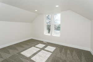 Additional living space featuring carpet floors, recessed lighting, and a textured ceiling