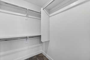 Walk in closet featuring dark colored carpet