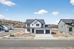 Modern inspired farmhouse with board and batten siding, driveway, a shingled roof, a garage, and a residential view