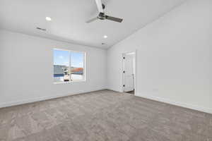 Empty room featuring light carpet, ceiling fan, lofted ceiling, and recessed lighting