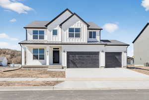 Modern farmhouse style home featuring board and batten siding, a porch, concrete driveway, roof with shingles, and an attached garage