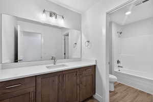 Bathroom featuring vanity, light wood finished floors, and shower / bath combination