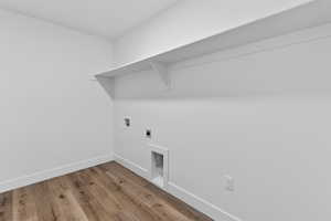 Laundry area featuring light wood-type flooring, electric dryer hookup, and washer hookup