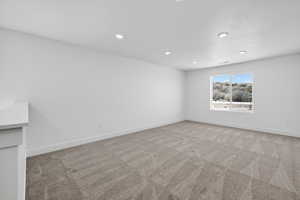 Unfurnished room featuring light colored carpet and recessed lighting