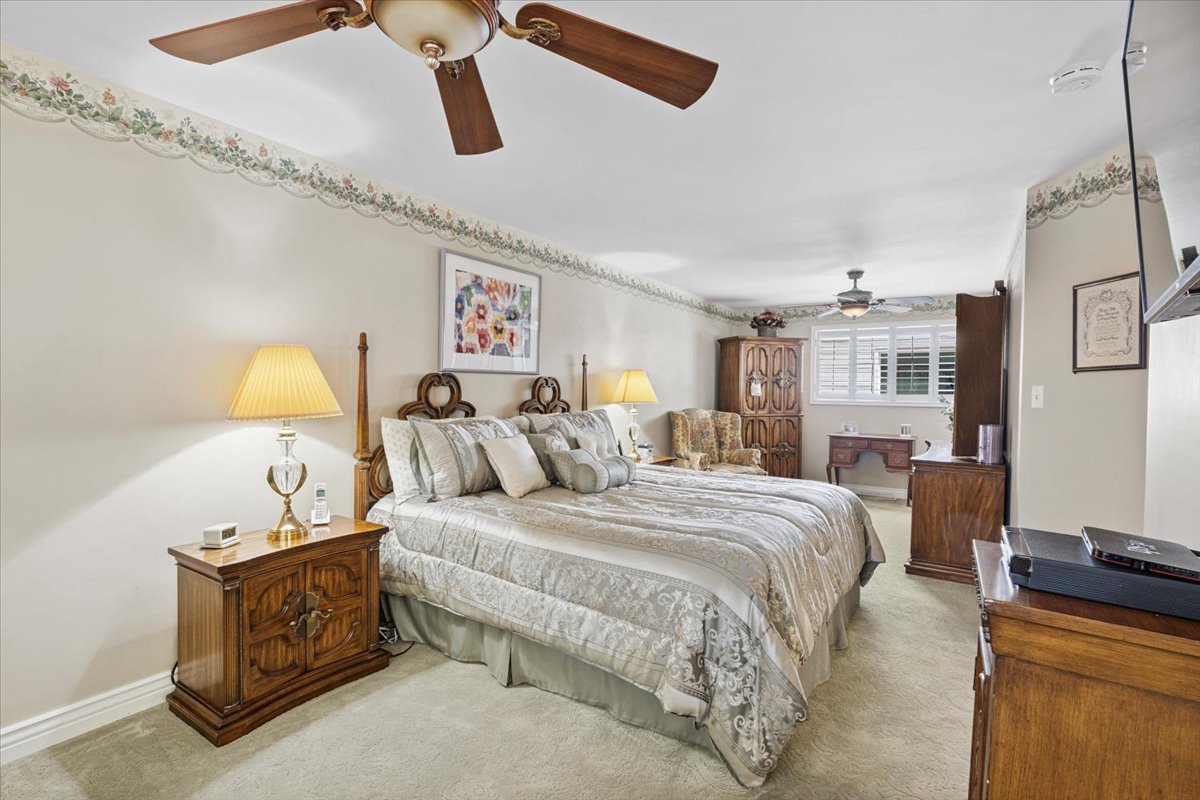 Bedroom with carpet flooring and a ceiling fan