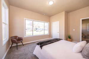 Carpeted bedroom featuring baseboards