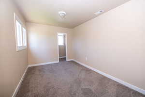 Spare room with carpet and baseboards