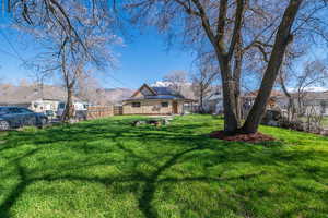 Fenced backyard with an outdoor fire pit and a mountain view