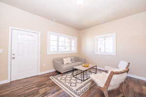 Living room with dark wood-type flooring