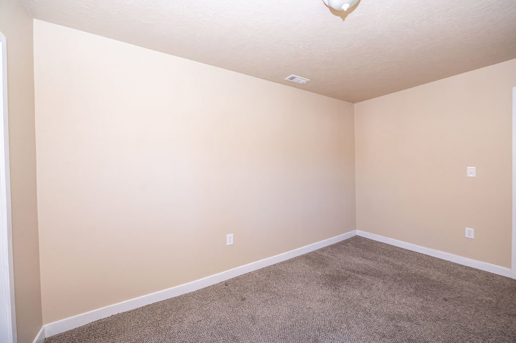 Spare room featuring carpet flooring and a textured ceiling