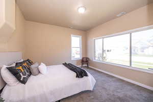 Carpeted bedroom featuring baseboards