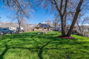Fenced backyard with a mountain view and an outdoor fire pit
